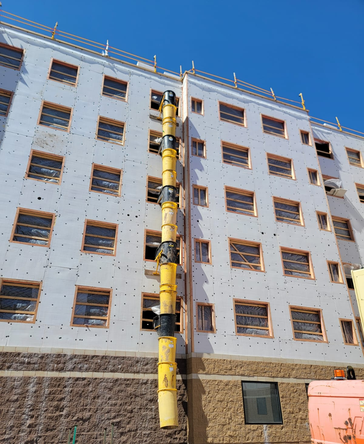 Debris chute mounted to scaffold showing variety of application options