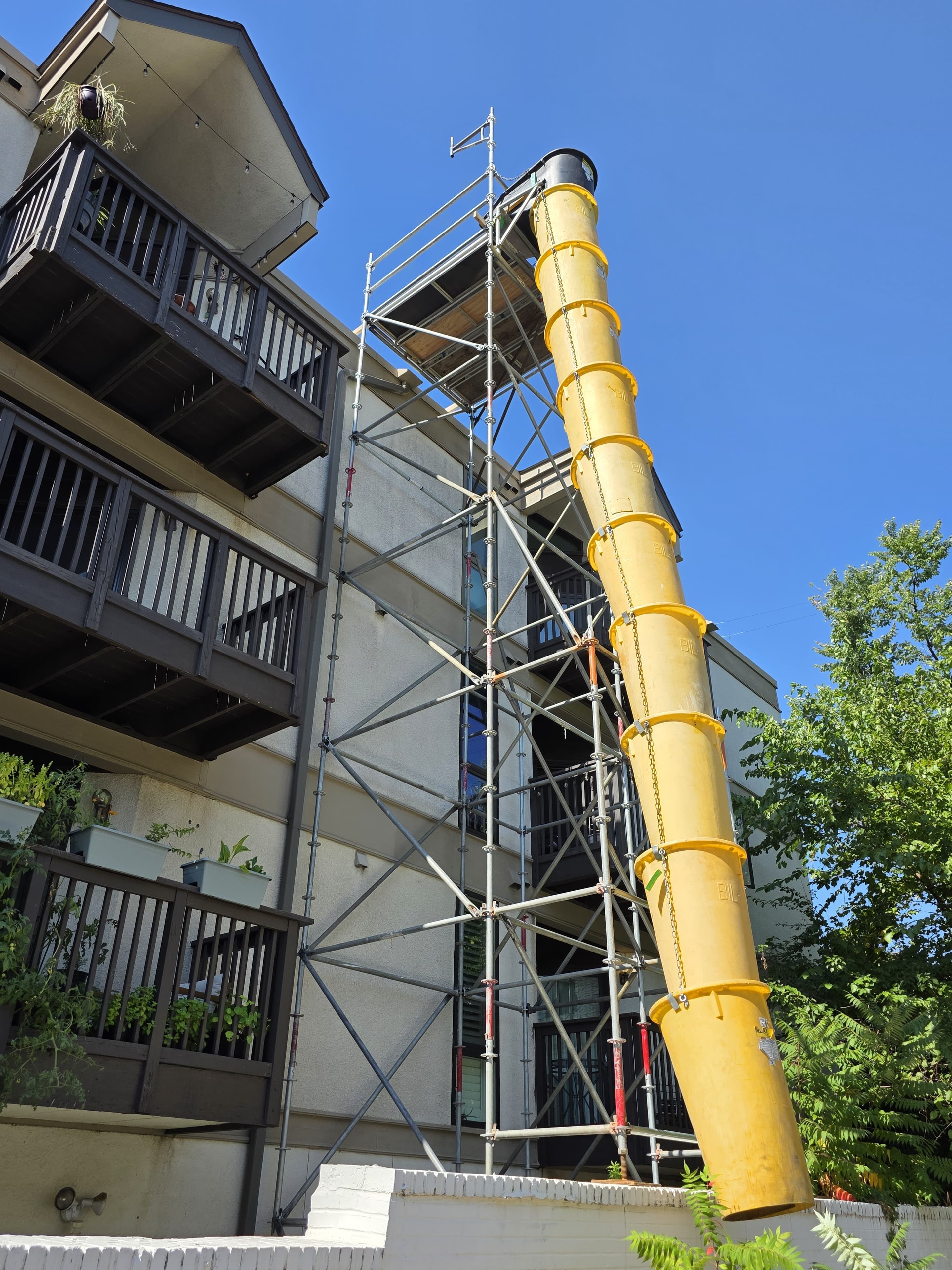 Debris chute attached to scaffold providing multi-level access