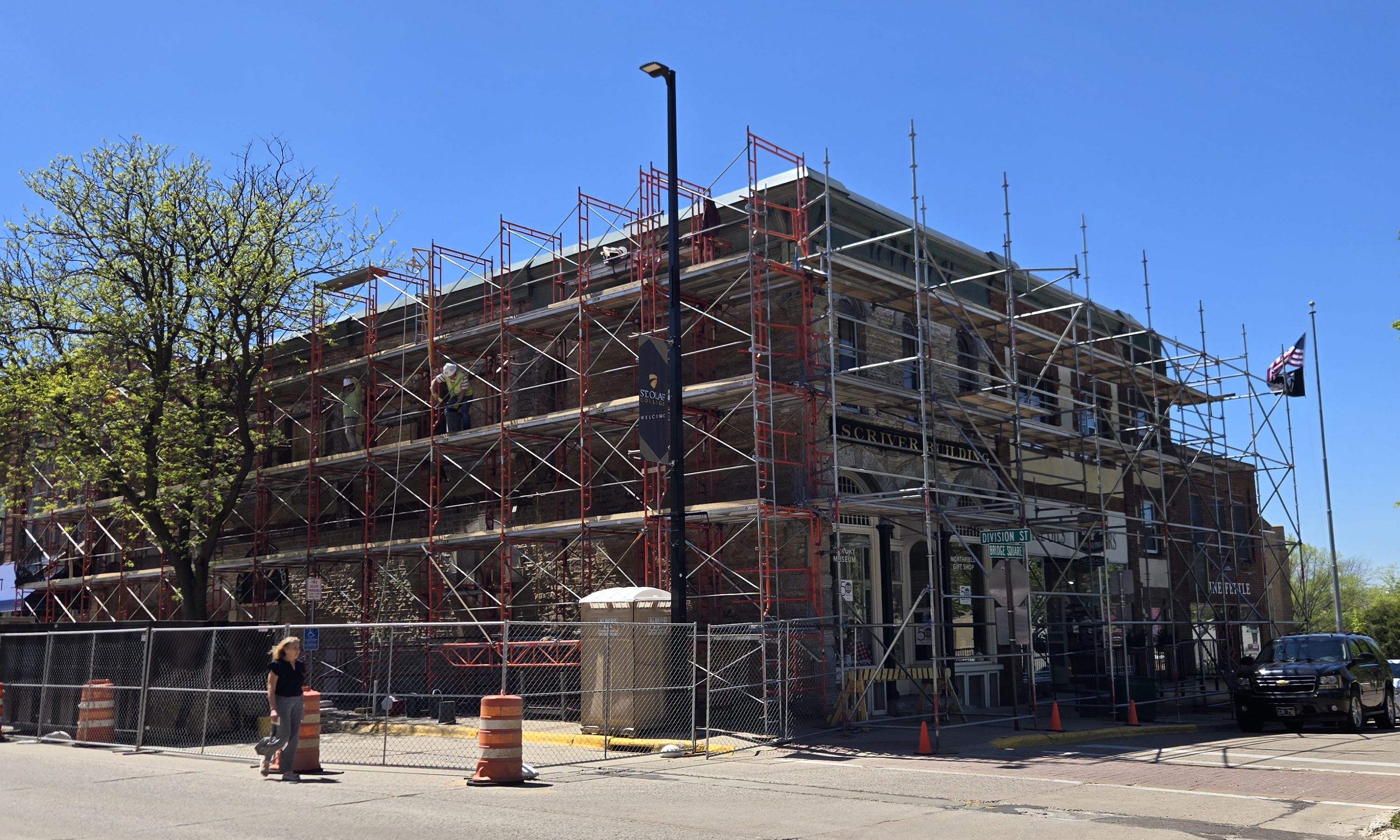 Brick storefront scaffolding with sidewalk pedestrian protection