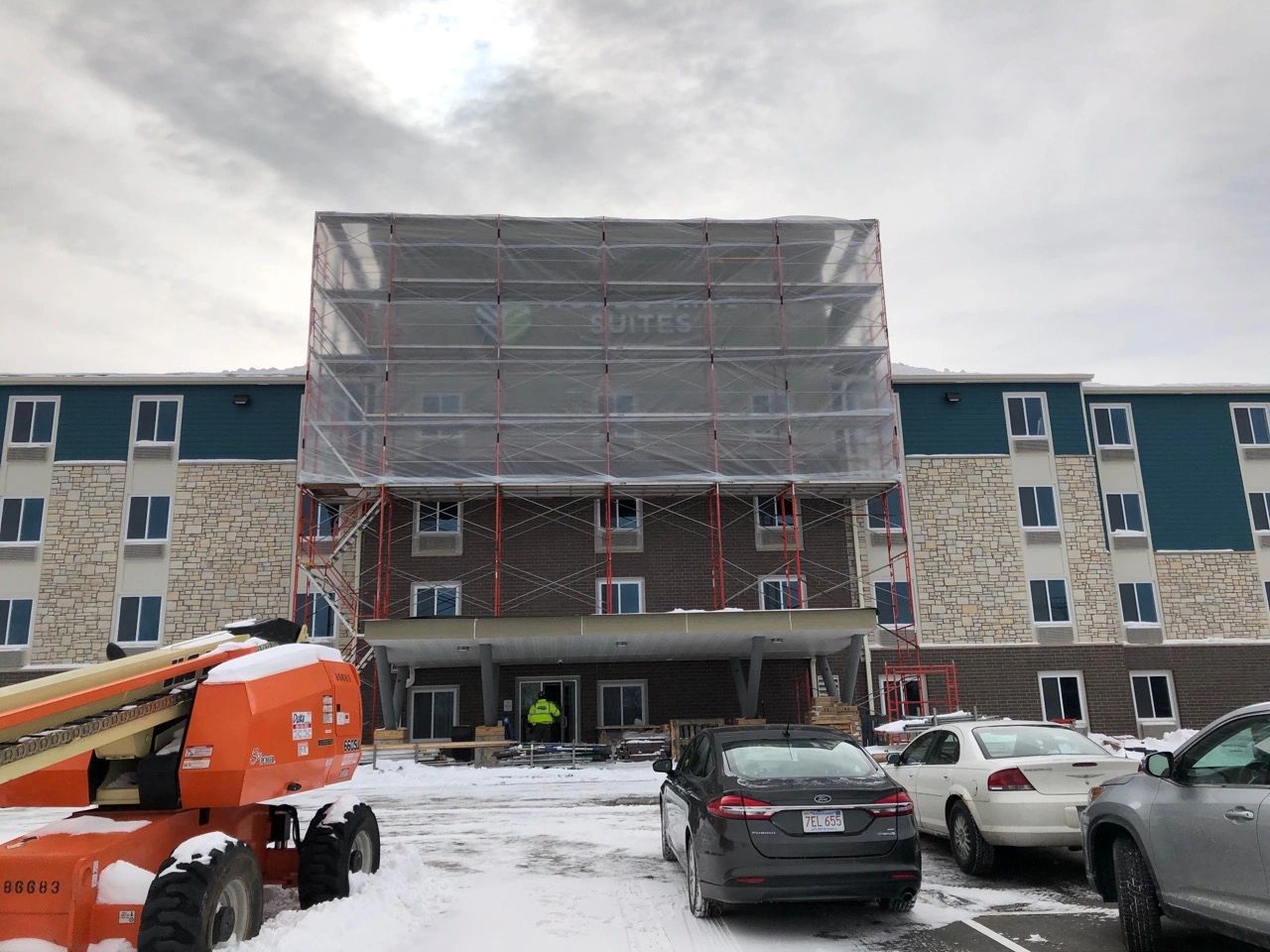 Scaffold enclosure concealing work at Woodspring Mendota building