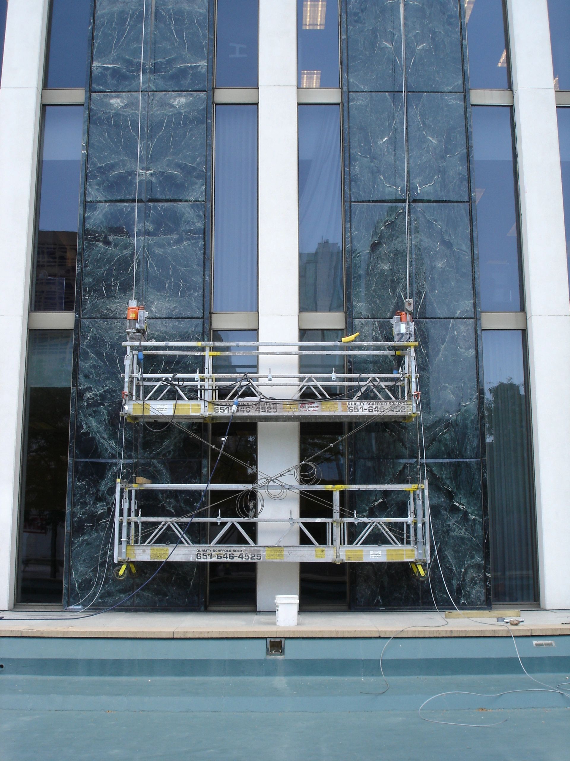 Swing stage with electric motor on a building
