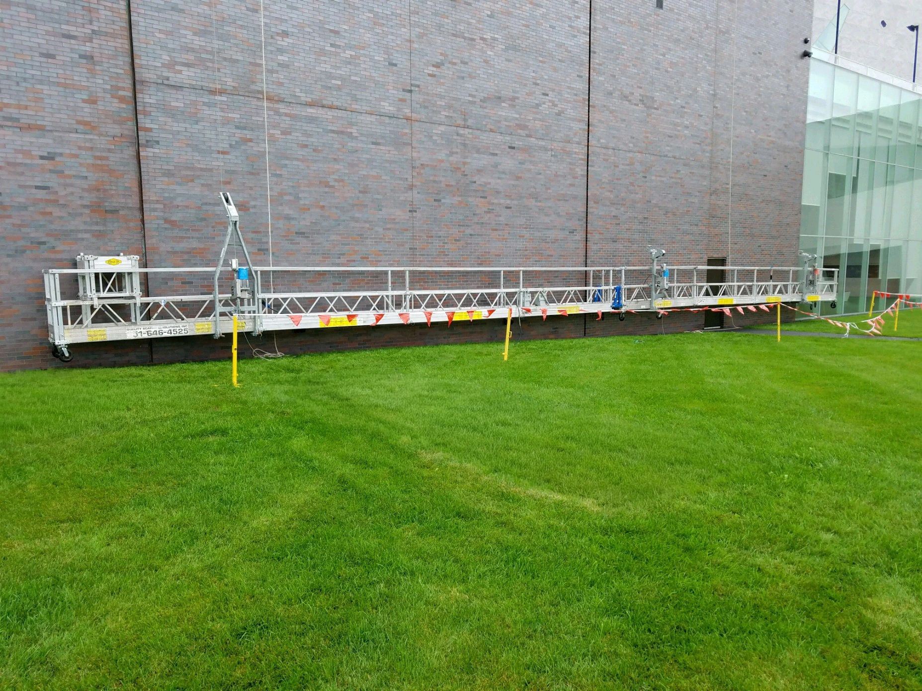 Swing stage scaffold on a building exterior